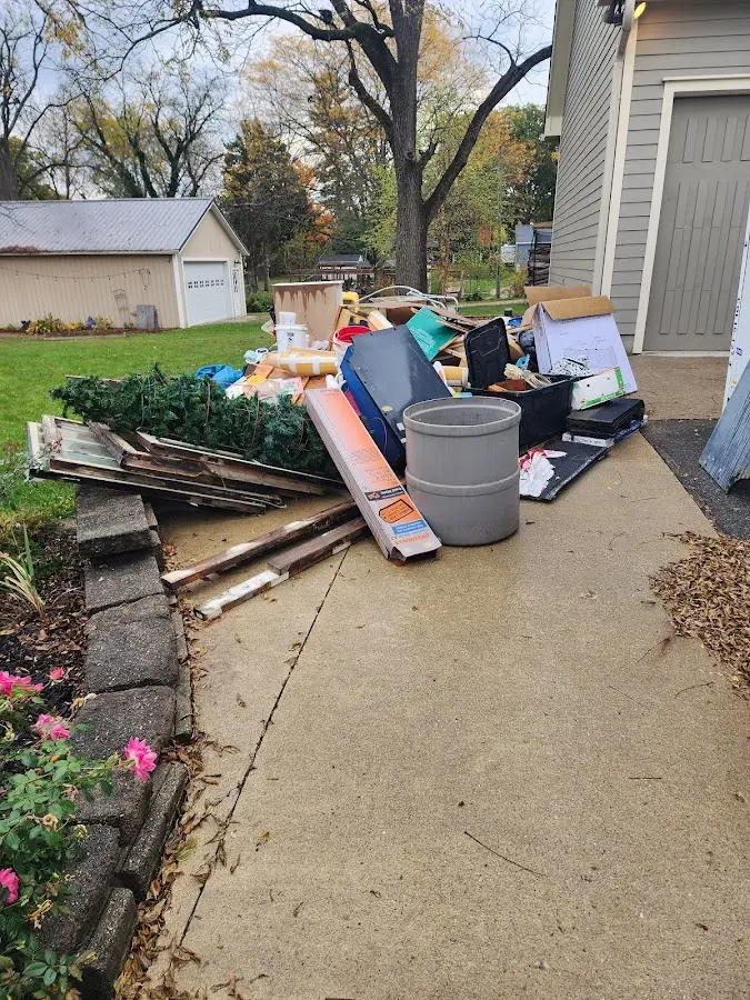 Dumpster being loaded with debris for Residential Dumpster Rental in Auberry